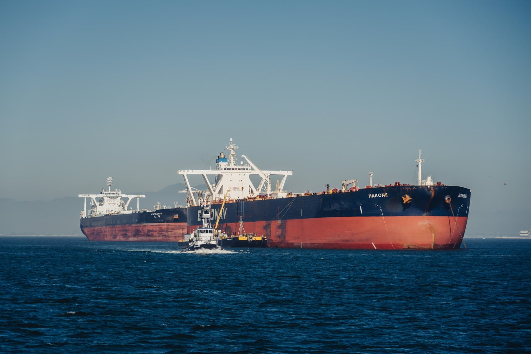 Two crude tankers at anchor on open water